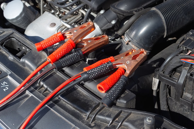 Jumper leads connected to a car battery